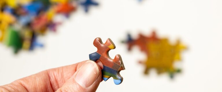 person holding jigsaw puzzle piece