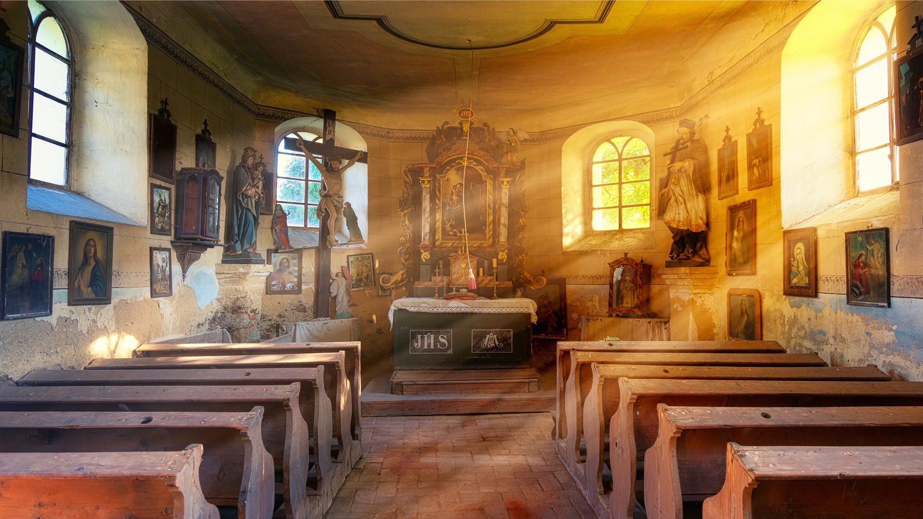 interior of old catholic church with bright rays of sun
